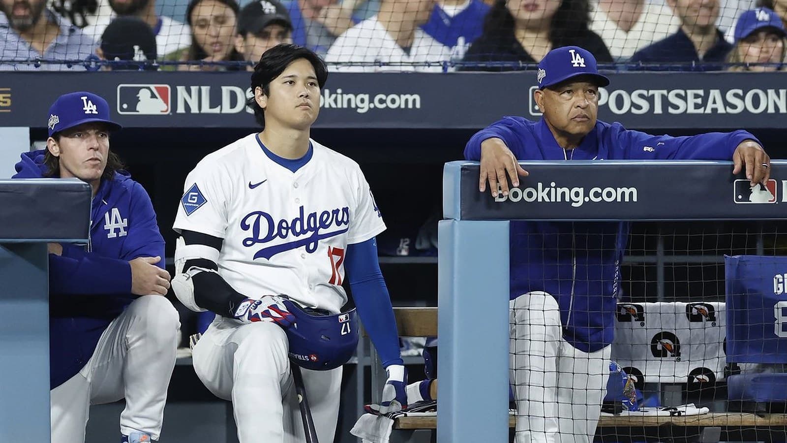 Shohei Ohtani, in his No. 17 Dodgers jersey, and teammates watch from the Dodger Stadium dugout during the postseason