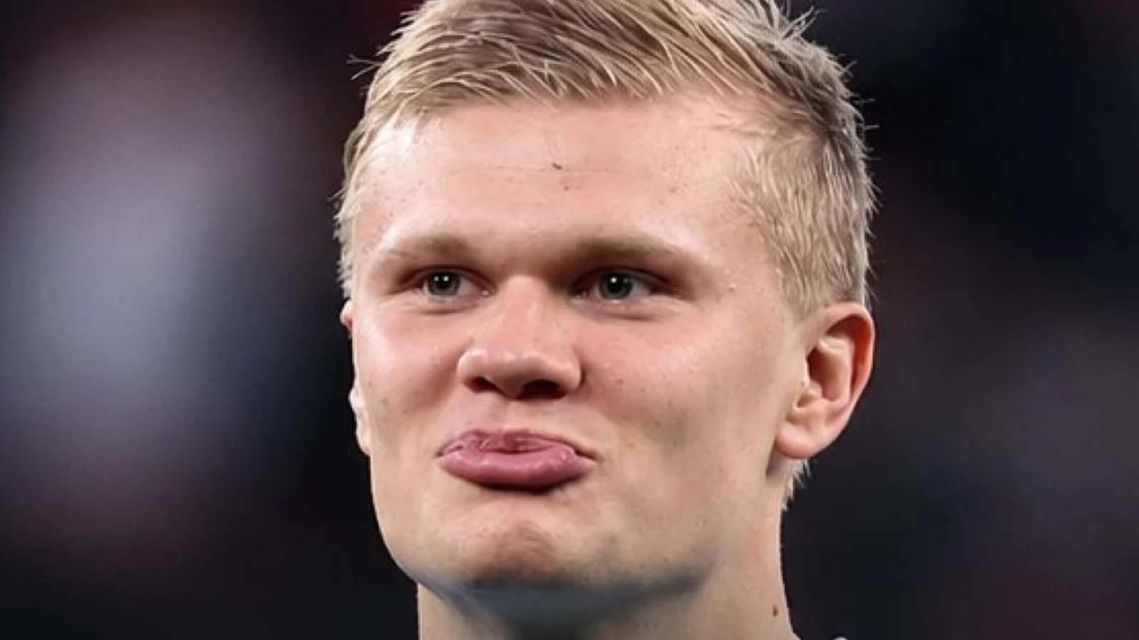 Erling Haaland in a Manchester City shirt, pursing his lips
